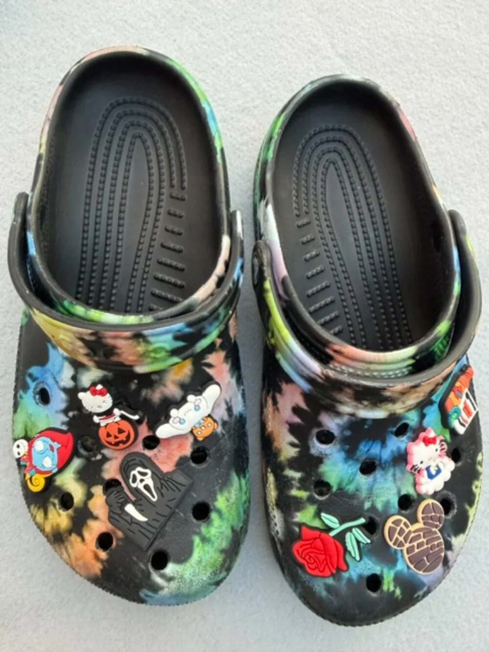 The product is a pair of Crocs Kids Size J 3 Black Tie-Dye Classic Clog Sandals